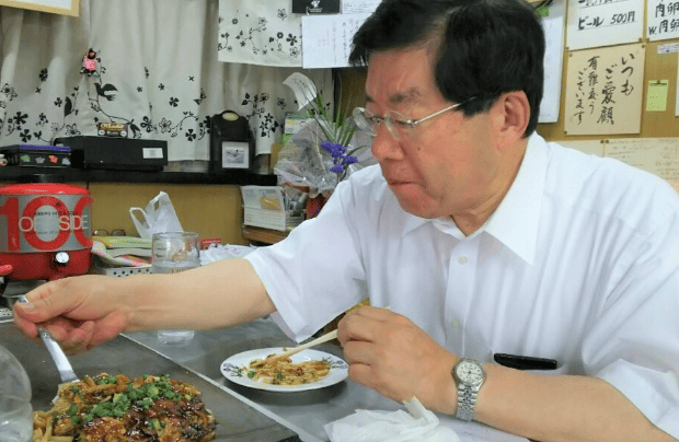 大好きなお好み焼を食べる平口洋